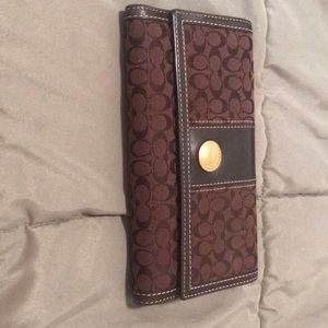 Coach, brown C wallet with check book cover.